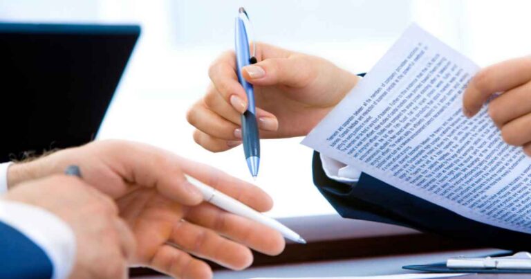 Two people discussing a printed document during a consultation.